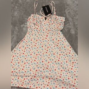 PrettyLittleThing cream ditsy floral tie front skater dress.